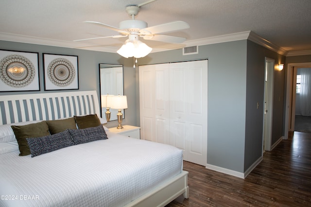 bedroom featuring ornamental molding, a textured ceiling, dark wood-type flooring, and ceiling fan