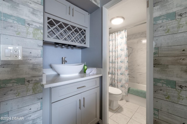 935 S Atlantic Ave Unit 509, Daytona Beach, FL 32118 - full bathroom with wood walls, toilet, vanity, shower / bathtub combination with curtain, and tile patterned flooring