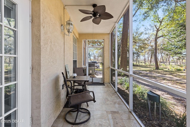 sunroom featuring ceiling fan