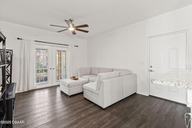 living area featuring dark wood-style floors, ceiling fan, baseboards, and french doors