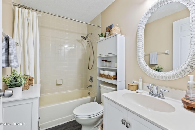 full bathroom with washtub / shower combination, a textured ceiling, toilet, and vanity