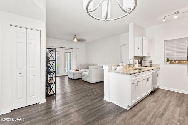 kitchen with dark wood-style flooring, a sink, and white cabinetry