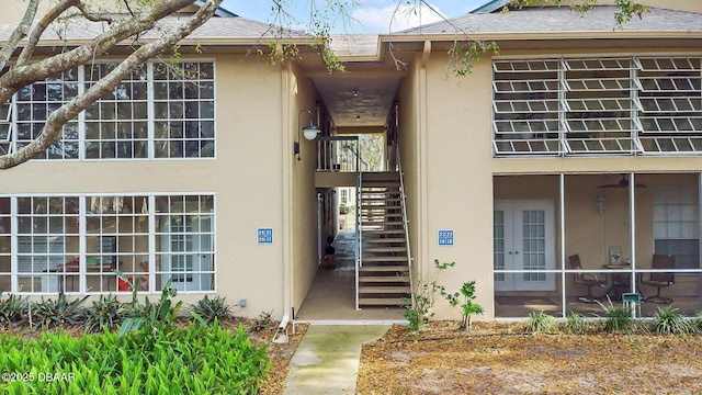 671 Wellington Station Blvd Unit 19, Ormond Beach, FL 32174 - view of side of property with stairway, roof with shingles, and stucco siding