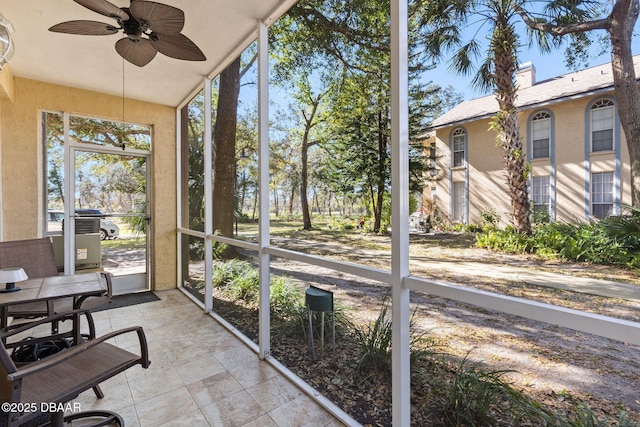 sunroom / solarium featuring ceiling fan