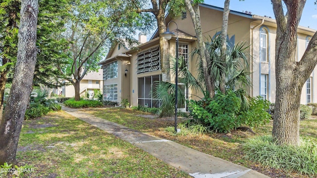 671 Wellington Station Blvd Unit 19, Ormond Beach, FL 32174 - exterior space featuring stucco siding and a chimney
