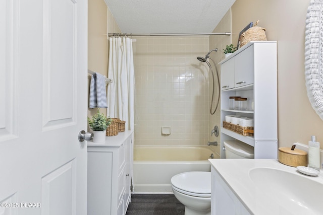 bathroom featuring shower / bath combination with curtain, a textured ceiling, toilet, and vanity