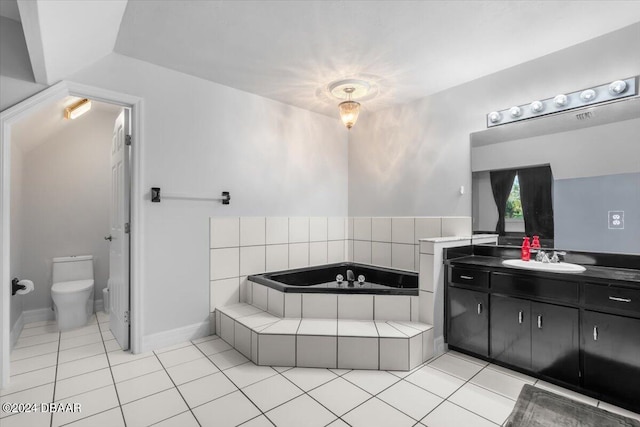 bathroom with toilet, tile patterned floors, a bath, and vanity