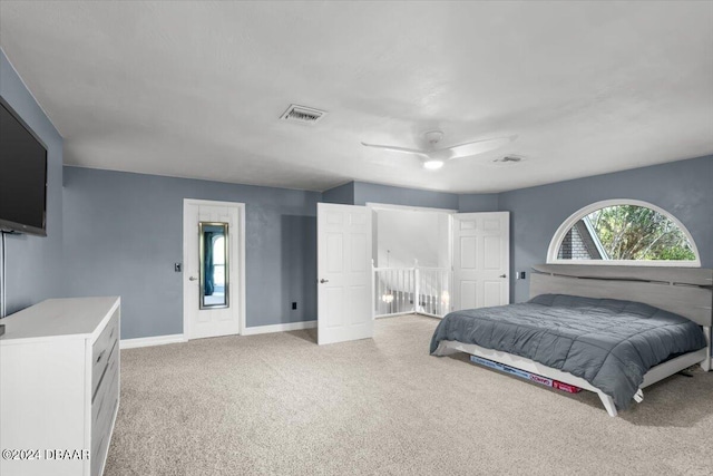 bedroom with light carpet, ceiling fan, visible vents, and baseboards