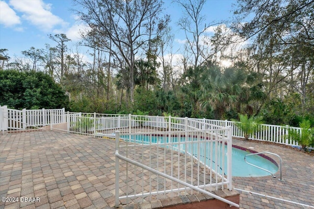 view of swimming pool with fence, a fenced in pool, and a patio