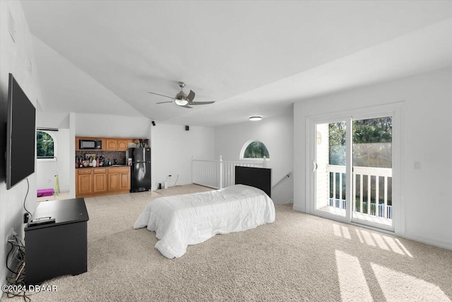 bedroom with lofted ceiling, light colored carpet, a ceiling fan, access to outside, and freestanding refrigerator