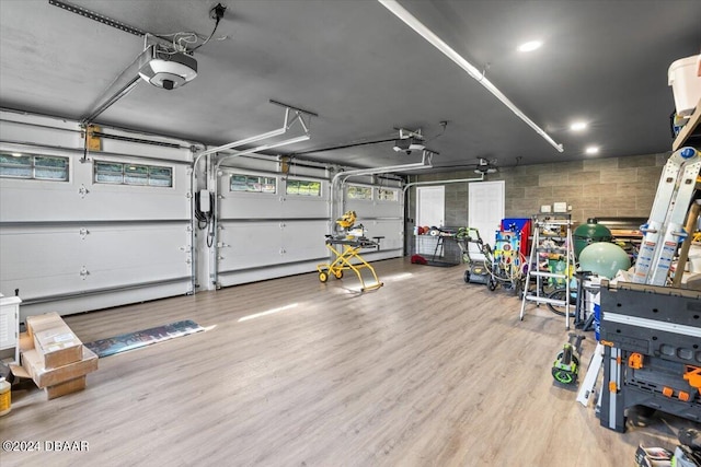 garage featuring concrete block wall and a garage door opener