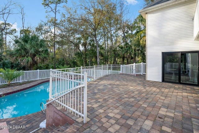 view of pool featuring a patio area, fence, and a fenced in pool