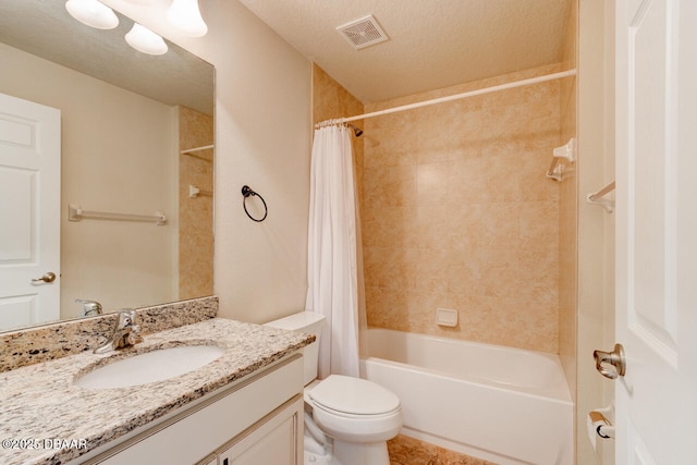 full bathroom featuring shower / bath combination with curtain, vanity, toilet, and a textured ceiling