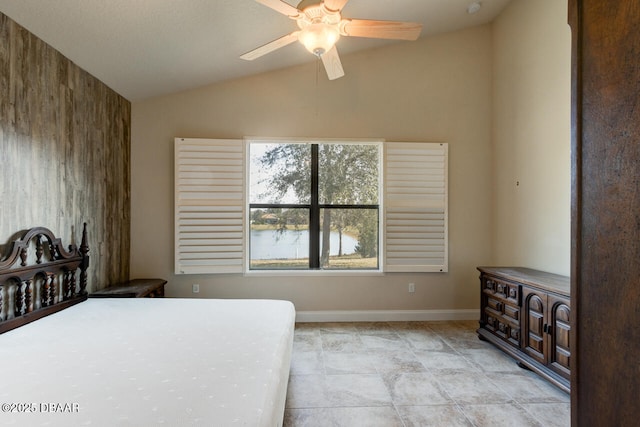 bedroom featuring a water view, lofted ceiling, and ceiling fan