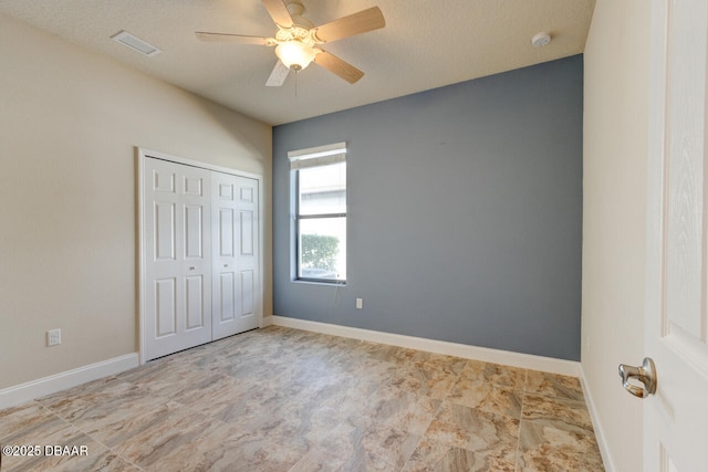 unfurnished bedroom featuring a closet and ceiling fan