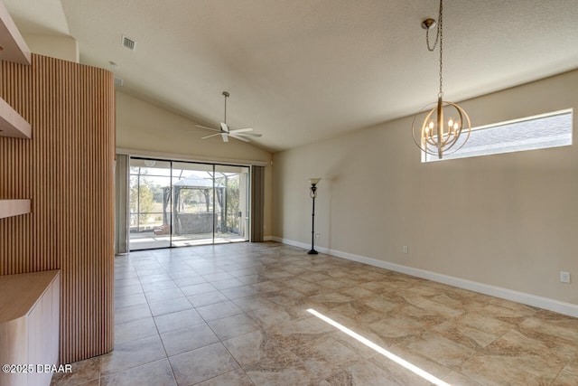 empty room with vaulted ceiling, ceiling fan with notable chandelier, and light tile patterned floors