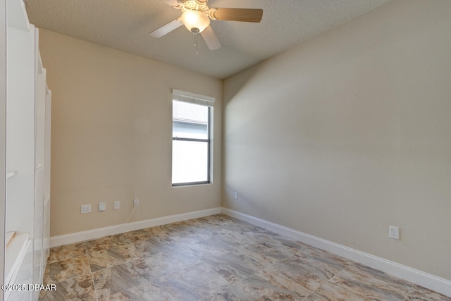 unfurnished room with ceiling fan and a textured ceiling