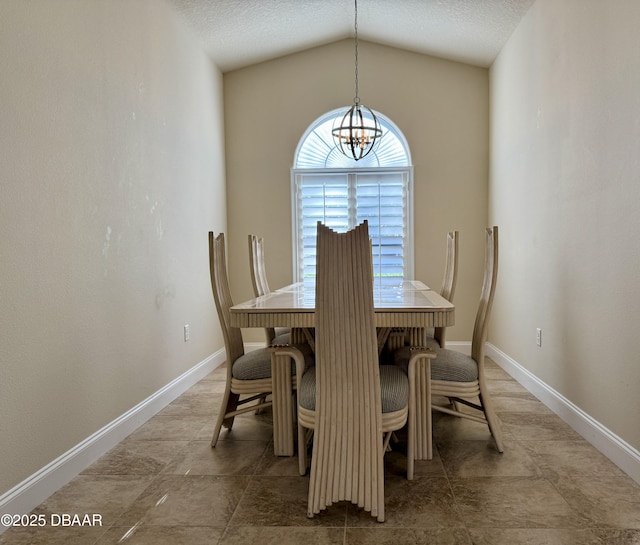 dining area with a chandelier, baseboards, vaulted ceiling, and a textured ceiling
