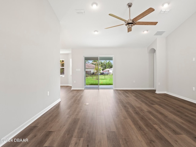 unfurnished living room with dark hardwood / wood-style floors and ceiling fan