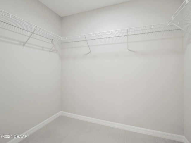 spacious closet with tile patterned floors