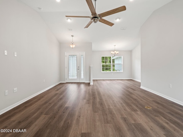 unfurnished living room with dark wood-type flooring, lofted ceiling, and ceiling fan with notable chandelier