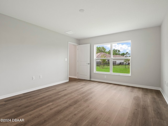 spare room with wood-type flooring