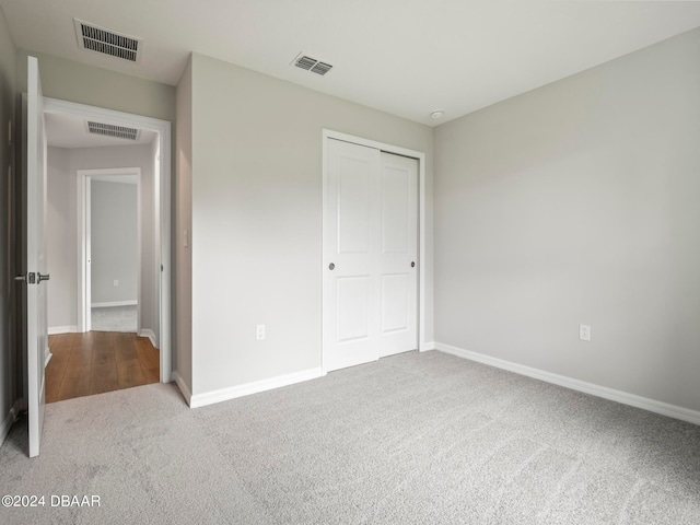 unfurnished bedroom with carpet floors and a closet