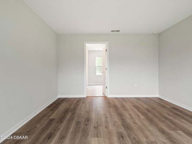 empty room with dark wood-type flooring