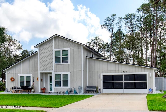 view of front of property with a garage and a front lawn