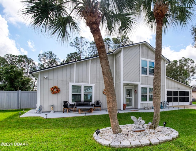 rear view of property featuring a yard