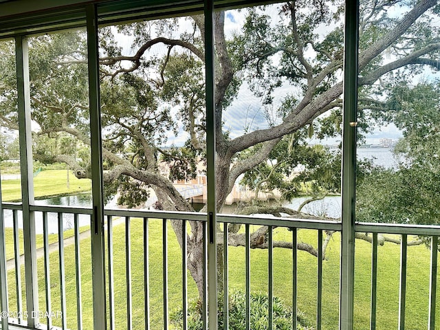 unfurnished sunroom with a water view