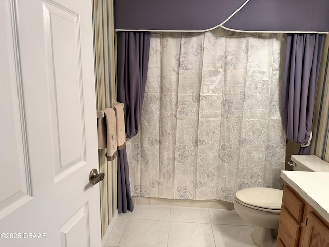 bathroom with tile patterned flooring, vanity, and toilet