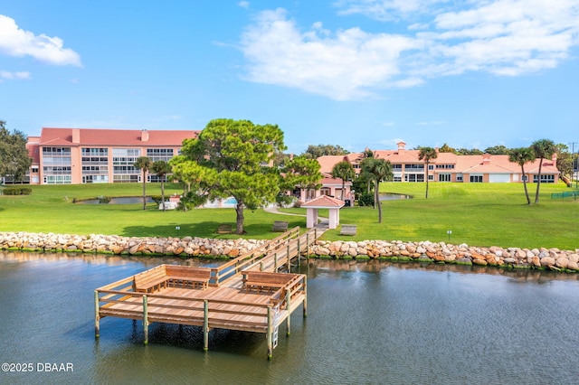 view of dock featuring a water view and a lawn