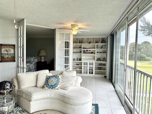 living room featuring ceiling fan and light tile patterned floors