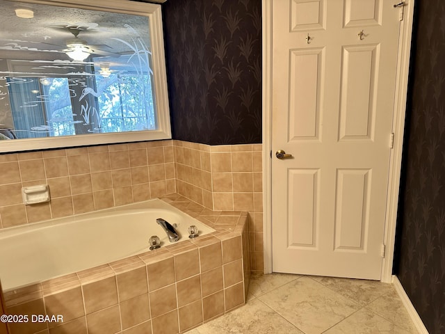 bathroom with tile patterned floors and a relaxing tiled tub