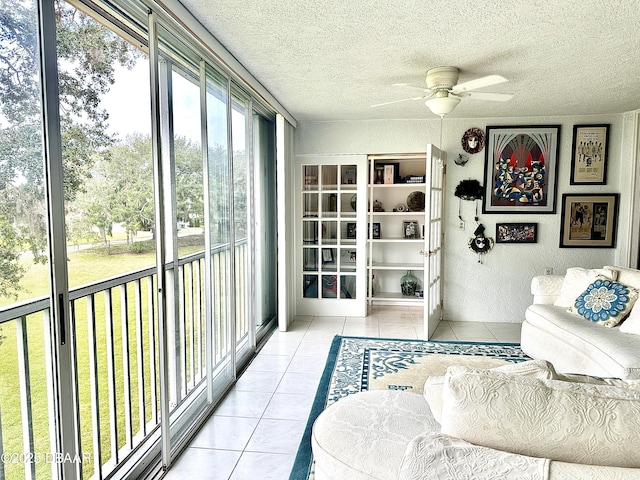 sunroom featuring ceiling fan