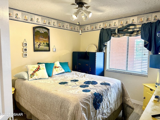 bedroom with wood-type flooring, a textured ceiling, and ceiling fan