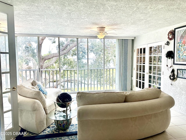 sunroom / solarium with french doors, a water view, and ceiling fan