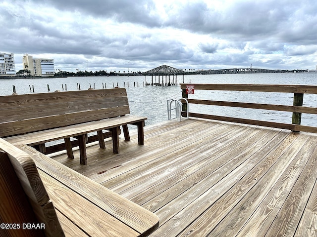 view of dock with a gazebo and a water view