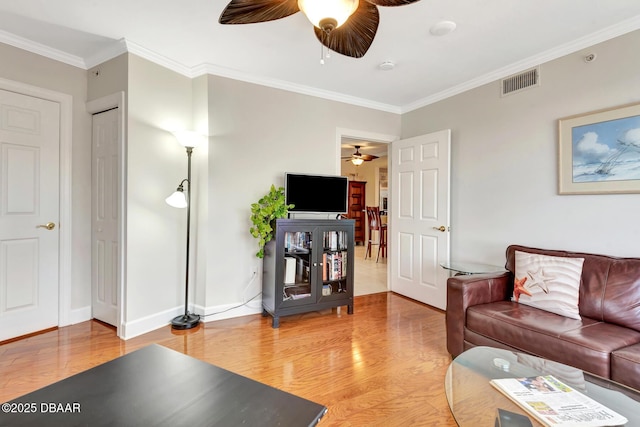 living room with wood-type flooring and crown molding