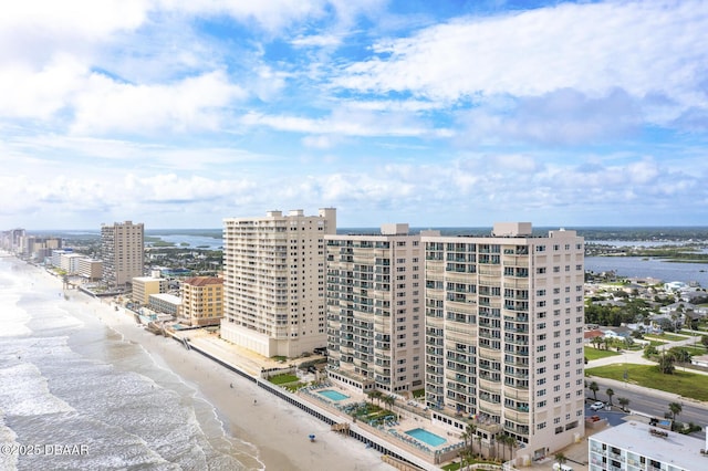 birds eye view of property with a water view and a view of the beach