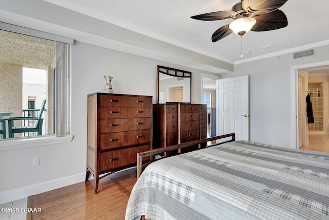 bedroom featuring ceiling fan, connected bathroom, ornamental molding, and wood-type flooring