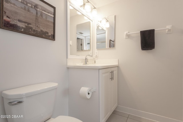 bathroom with vanity, toilet, and tile patterned flooring