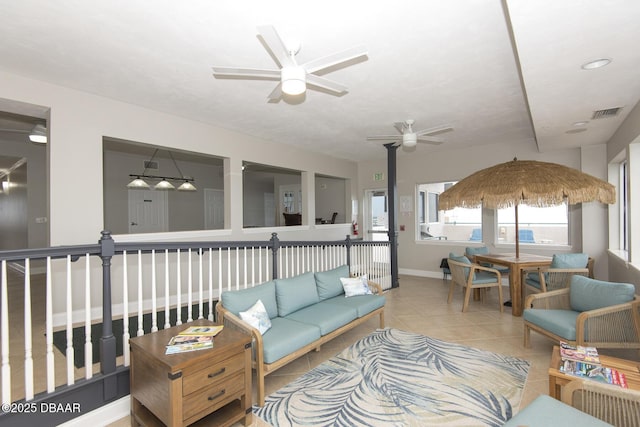 living room with ceiling fan and light tile patterned floors