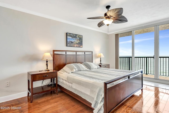 bedroom with wood-type flooring, a water view, ornamental molding, access to outside, and ceiling fan