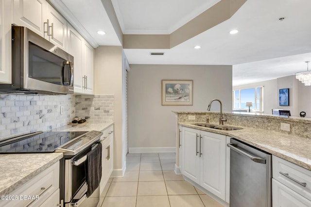 kitchen featuring sink, white cabinetry, stainless steel appliances, and tasteful backsplash