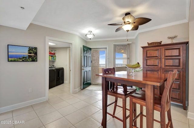 tiled dining room with washing machine and dryer, ceiling fan, and crown molding