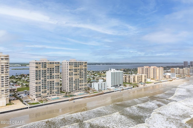 bird's eye view with a water view and a beach view