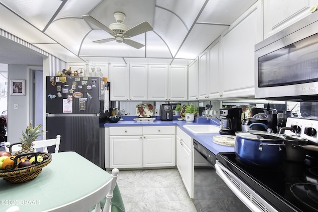 kitchen featuring sink, black appliances, white cabinets, and ceiling fan