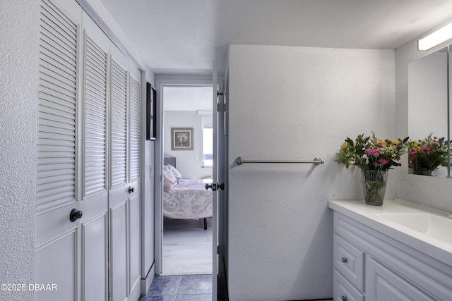 bathroom with vanity and tile patterned flooring